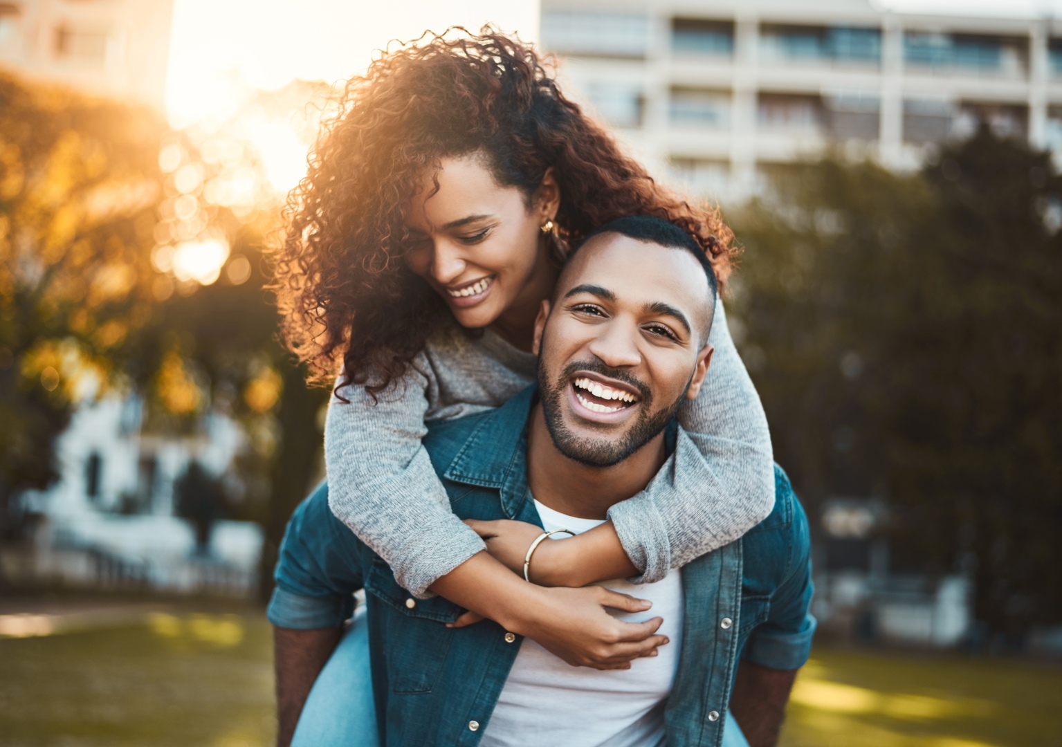 Couple,,Piggyback,And,Portrait,In,Park,,Laughing,And,Relationship,Bonding